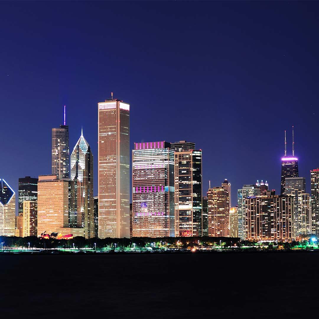City skyline at night with illuminated skyscrapers