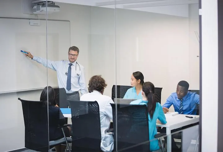 Instructor leading a medical training session in a classroom setting