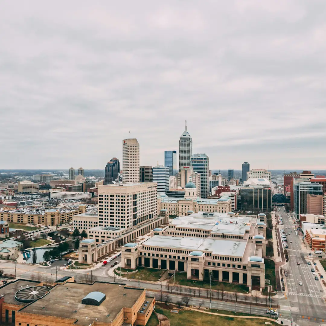 Indianapolis skyline cityscape with downtown buildings under cloudy sky