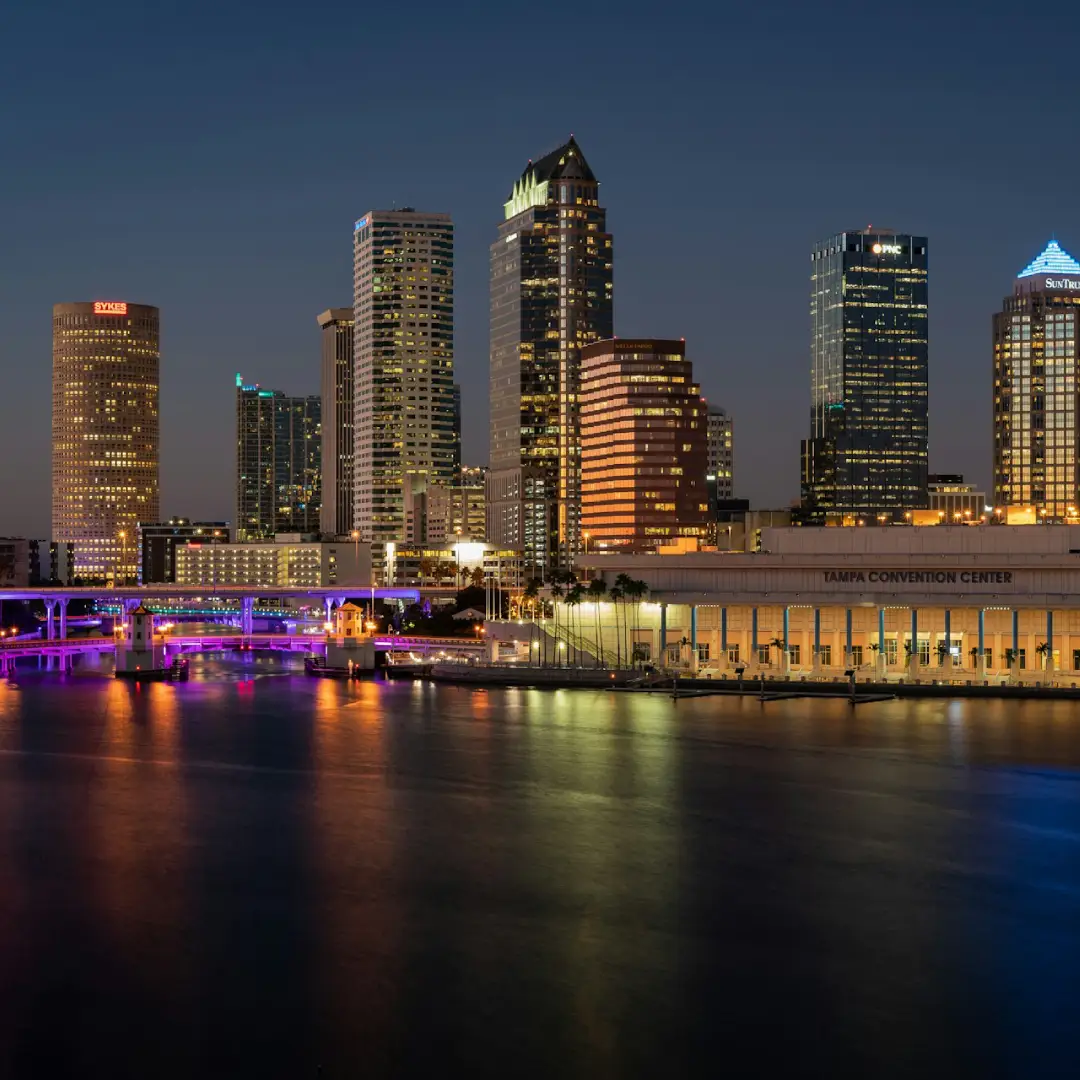 Tampa skyline at night with buildings reflected on the waterfront