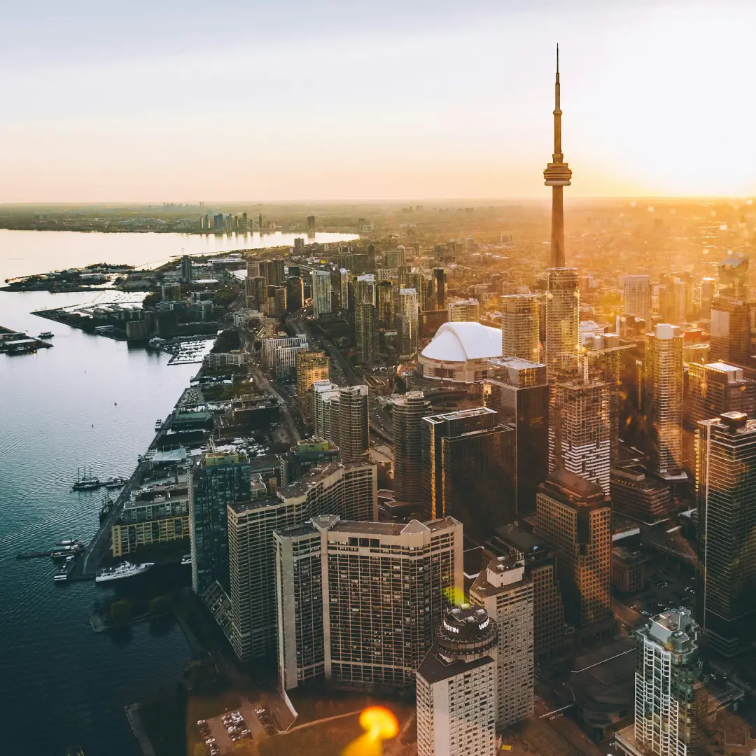 Toronto skyline at sunset with waterfront and high rise buildings