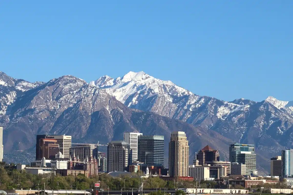 Salt lake city skyline below snow capped mountains