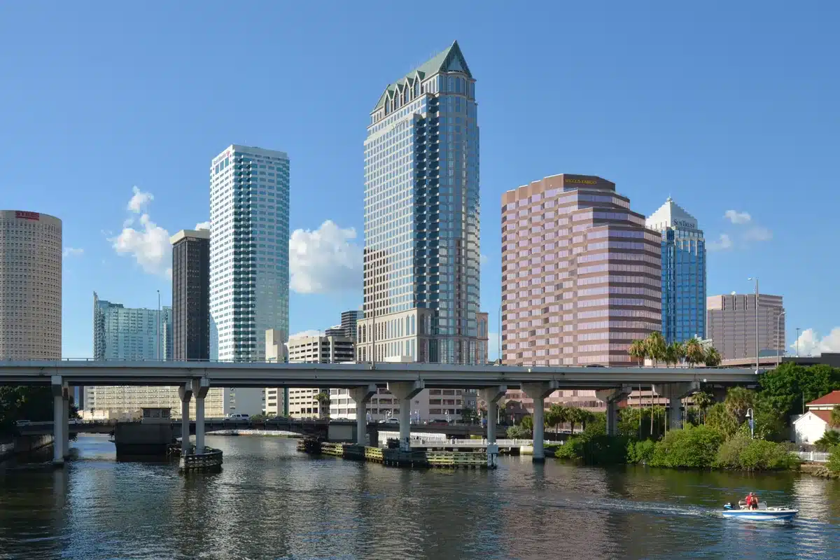 Downtown tampa towers above the river and a bridge